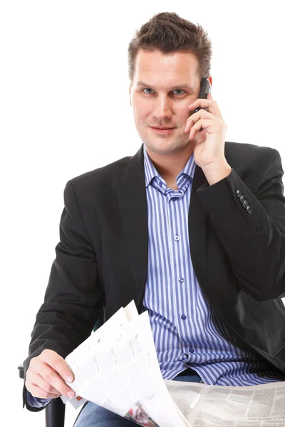 Man reads newspaper phoning - economy news — Stock Photo, Image