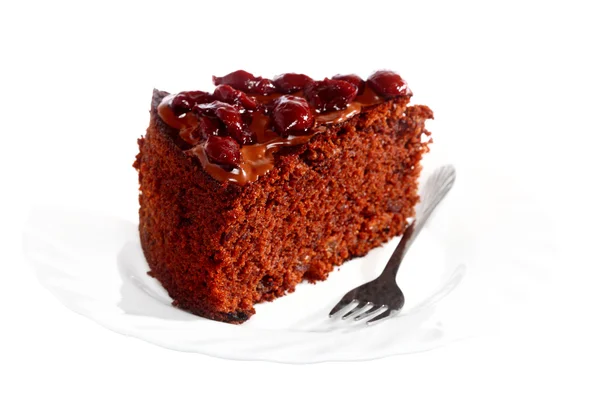 Piece of chocolate cake with icing and cherry — Stock Photo, Image