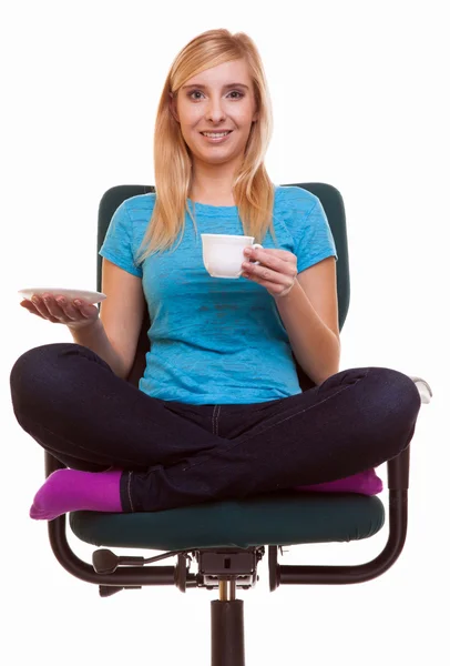 Beautiful girl relaxing in chair holds a cup of tea or coffee. — Stock Photo, Image