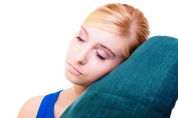 Sleepy blond girl with green pillow isolated over white — Stock Photo, Image