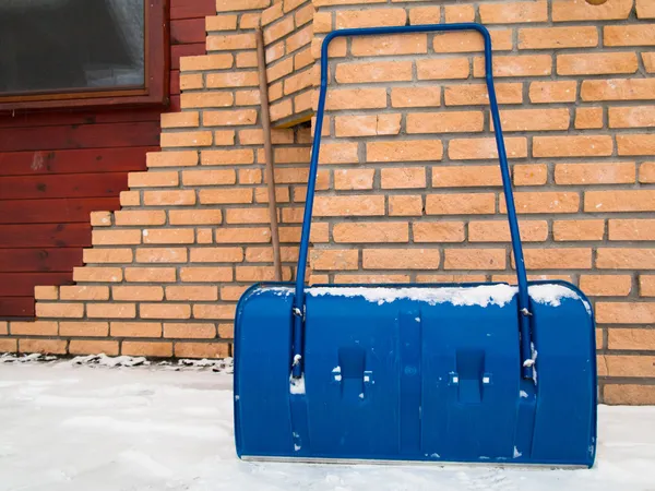 Pá de neve azul durante o dia nevado, tempo de inverno — Fotografia de Stock