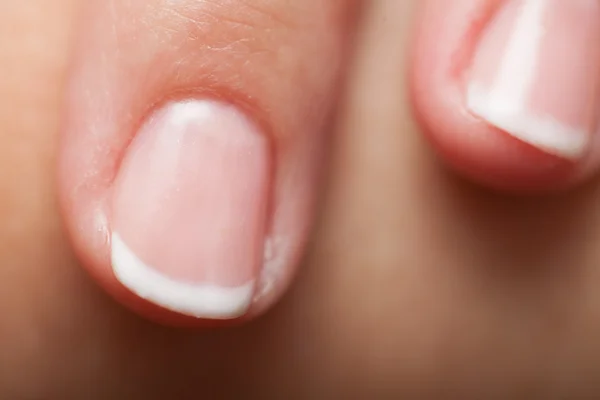 Close-up of woman fingers with french manicure — Stock Photo, Image