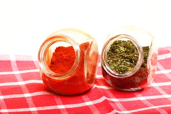 Jars with spices paprika and lovage isolated — Stock Photo, Image