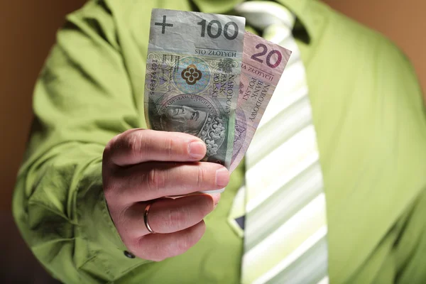 Businessman holding money 100 polish zloty — Stock Photo, Image