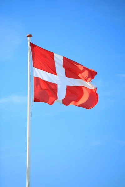 Danish flag with blue sky on background — Stock Photo, Image