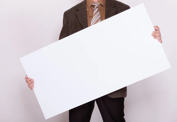 Businessman holding blank billboard. Advertising. — Stock Photo, Image