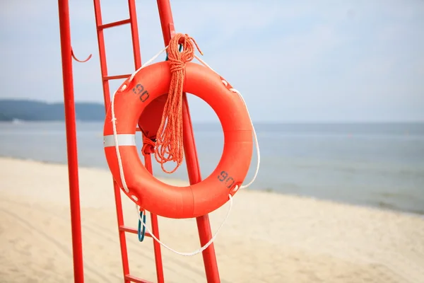 Lifeguard beach rescue equipment orange lifebuoy — Stock Photo, Image