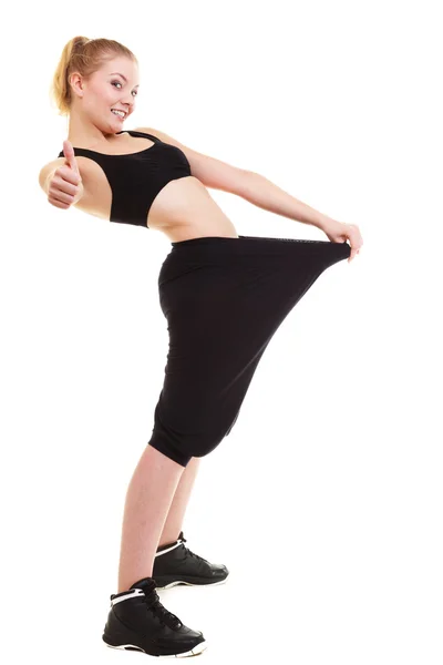 Fitness woman with big pants thumbs up — Stock Photo, Image