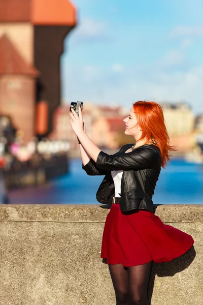 Fashionable tourist girl taking picture with camera old town Gdansk — Stock Photo, Image