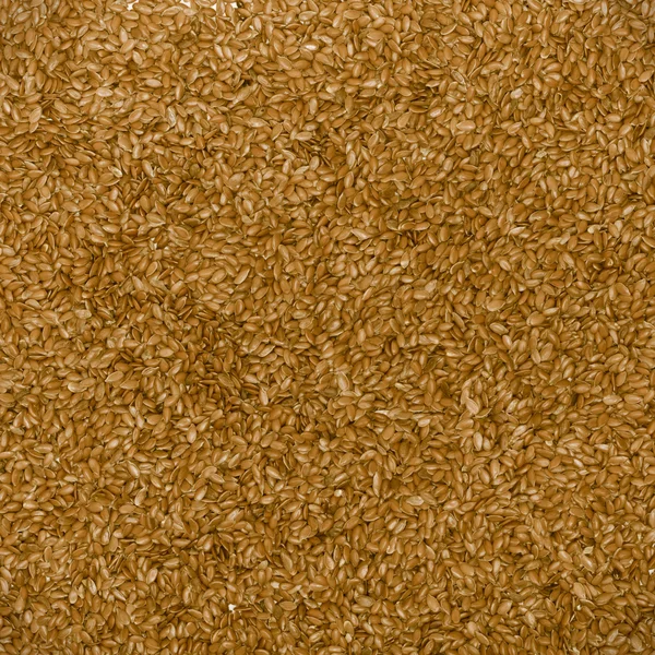 Zblízka lněný lněné semeno hnědé potravin texturu pozadí — Stock fotografie