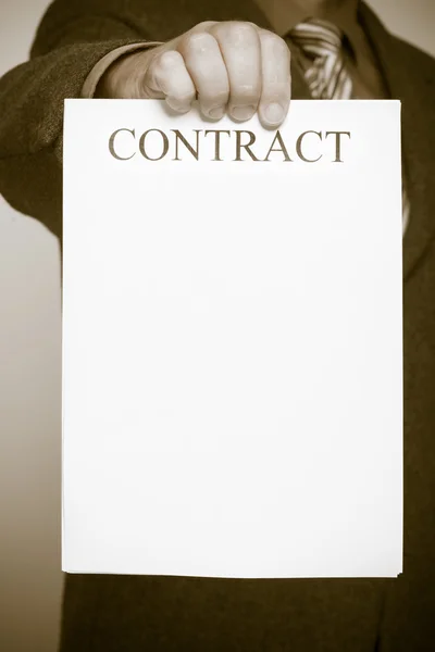 Businessman holding blank paper with sign contract — Stock Photo, Image