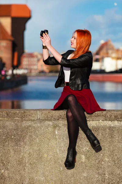 Traveler woman red hair girl with camera old town Gdansk — Stock Photo, Image