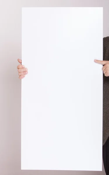 Businessman holding blank billboard. Advertising. — Stock Photo, Image