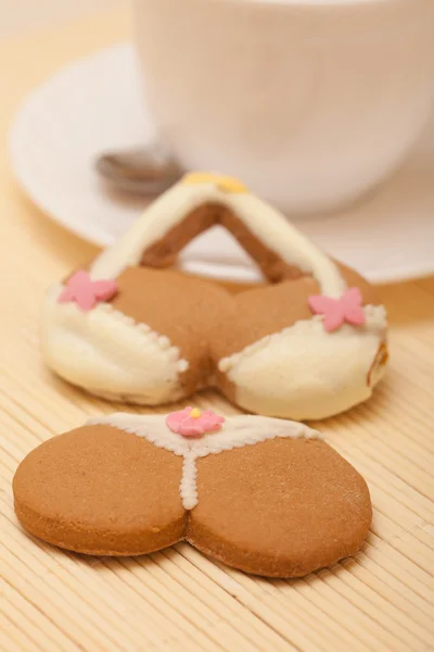 White cup bikini underwear gingerbread cake cookie on bamboo mat — Stock Photo, Image