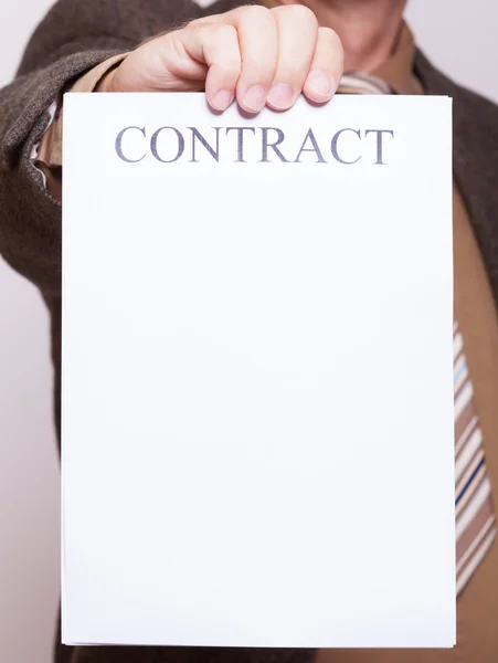 Businessman holding blank paper with sign contract — Stock Photo, Image