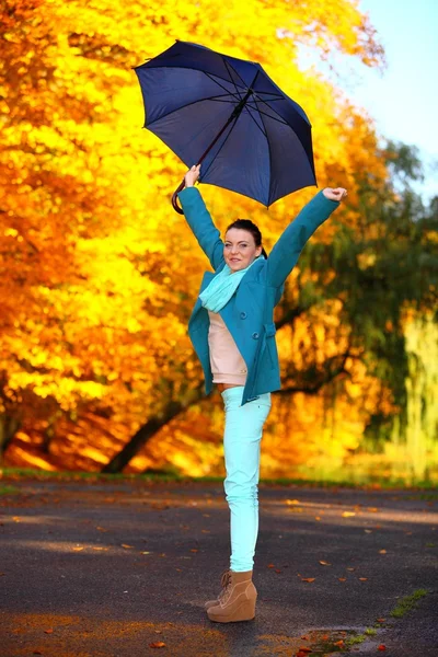 Junges Mädchen spaziert mit Regenschirm durch herbstlichen Park — Stockfoto