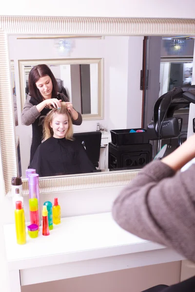 Vacker blond flicka hår papiljotter rullar frisör skönhetssalong — Stockfoto