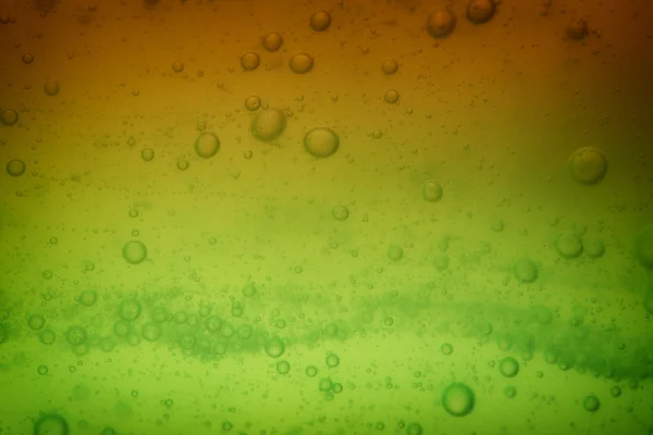 Bolle di sapone verde fondo liquido — Foto Stock