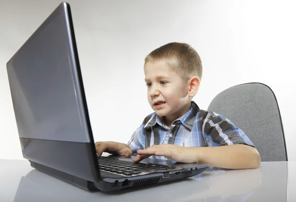 Computer addiction emotional boy with laptop — Stock Photo, Image