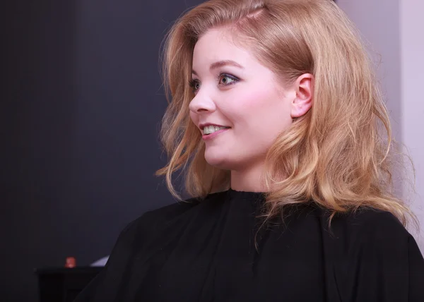 Schöne lächelnde Mädchen mit blonden welligen Haaren vom Friseur im Schönheitssalon — Stockfoto
