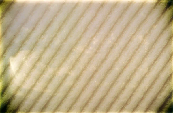 Closeup beige spons schuim met vignet als achtergrondstructuur — Stockfoto