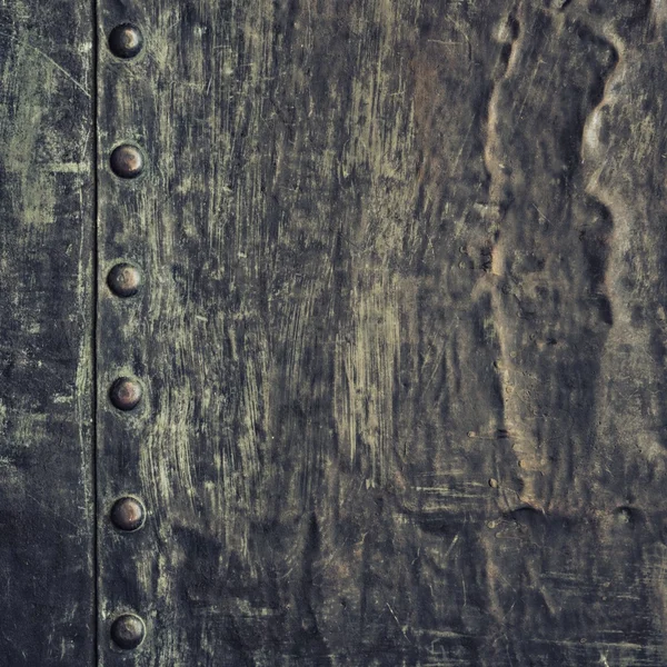 Grunge black metal plate with rivets screws background texture — Stock Photo, Image