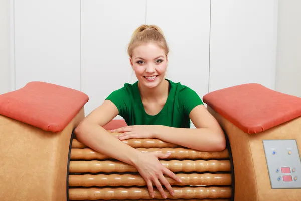 Girl in sportwear using relax massage equipment healthy spa salon — Stock Photo, Image