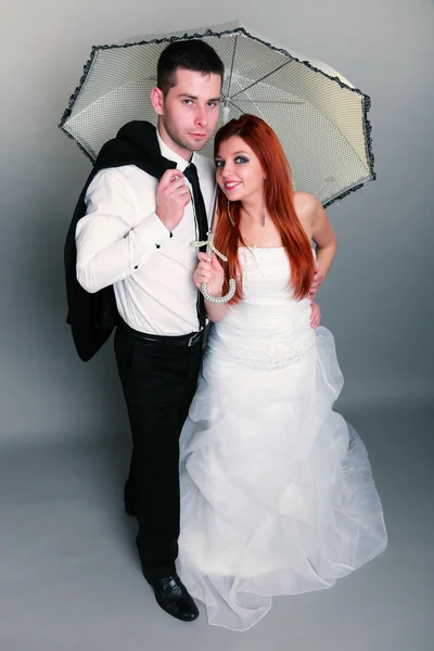 Happy married couple bride groom on gray background — Stock Photo, Image