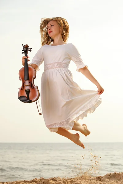 Happy blonde girl with a violin outdoor — Stock Photo, Image