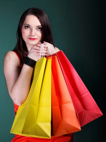 Woman with paper multi coloured shopping bag — Stock Photo, Image