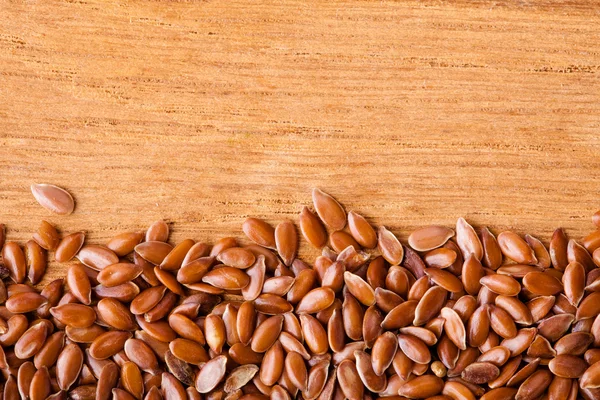 Healthy diet. Flax seeds linseed border on wooden background — Stock Photo, Image