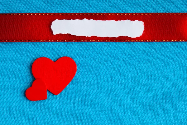 Valentines day background. paper blank hearts on blue fabric material Royalty Free Stock Images