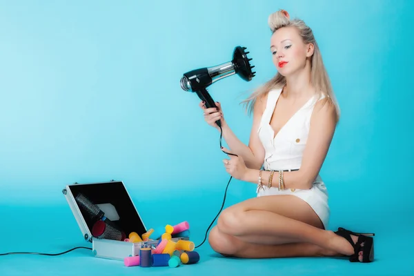 Sexy girl retro style in curlers with hairdryer styling hair — Stock Photo, Image