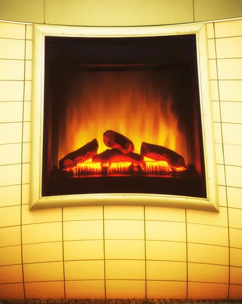 Kominek elektryczny sztuczny ogień pomarańczowy płomień wnętrza. reklamy. — Zdjęcie stockowe