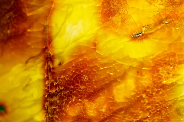 Closeup of golden amber as background or texture. Resin gem. — Stock Photo, Image
