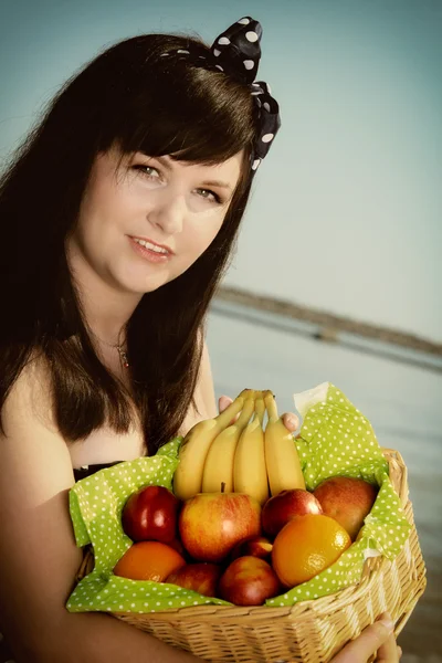 Lang haar vrouw houden mand fruit zomer — Stockfoto