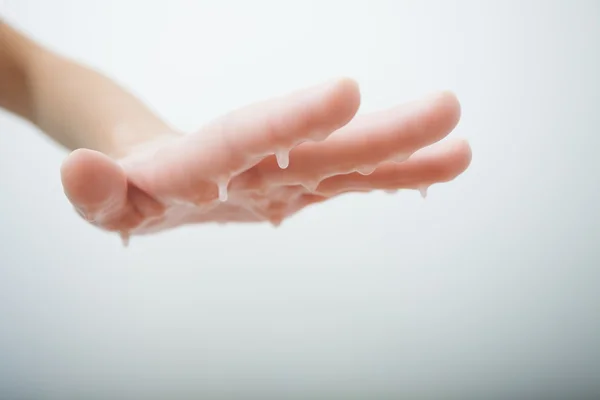 Mano femenina y baño de cera parrafina. Salón de belleza de manicura spa . —  Fotos de Stock