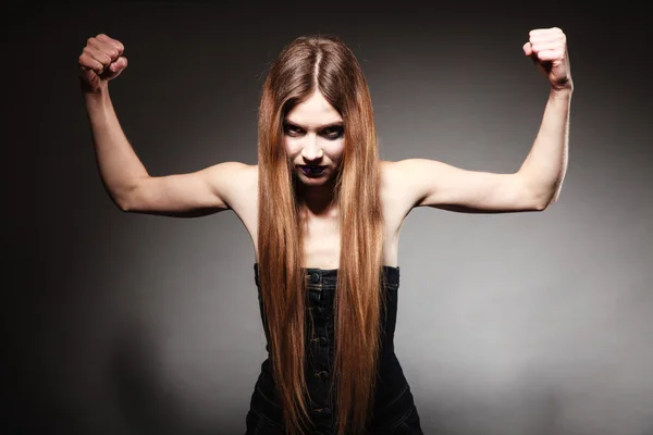 Sad girl with long hair and creative makeup showing her muscles — Stock Photo, Image