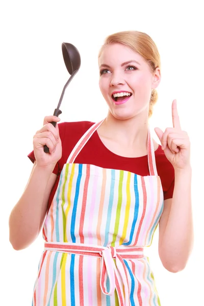 Funny housewife or cook chef in colorful kitchen apron with ladle — Stock Photo, Image