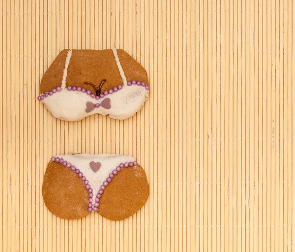 White violet bikini shape gingerbread cake cookie on bamboo mat — Stock Photo, Image