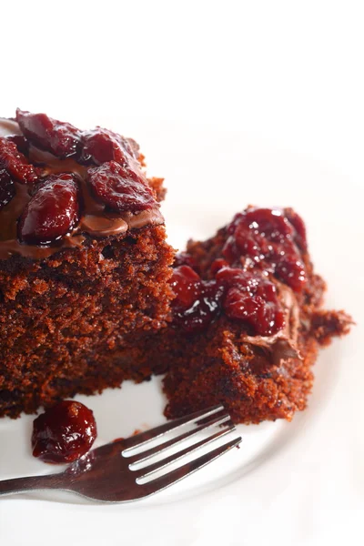 Piece of chocolate cake with icing and cherry — Stock Photo, Image