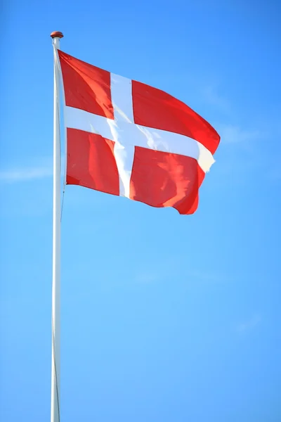 Danish flag with blue sky on background — Stock Photo, Image