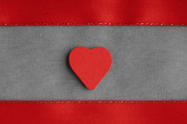 Red wooden decorative heart on grey gray cloth background. Royalty Free Stock Photos
