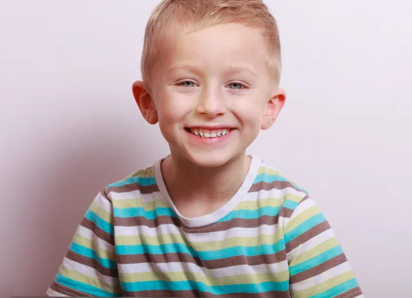 Portrait of happy laughing blond boy child kid at the table — Stock Photo, Image