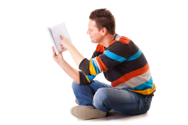 Male student reading a book preparing for exam isolated — Stock Photo, Image