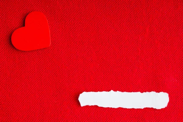 Piece paper blank copyspace heart on red fabric textile material Royalty Free Stock Photos