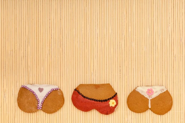 Funny bikini panties shape gingerbread cakes cookies bamboo mat — Stock Photo, Image