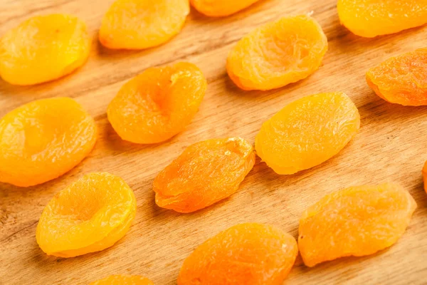 Dried apricots set on wooden table background. — Stock Photo, Image