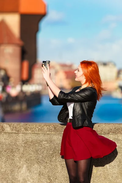 Traveler woman red hair girl with camera old town Gdansk — Stock Photo, Image