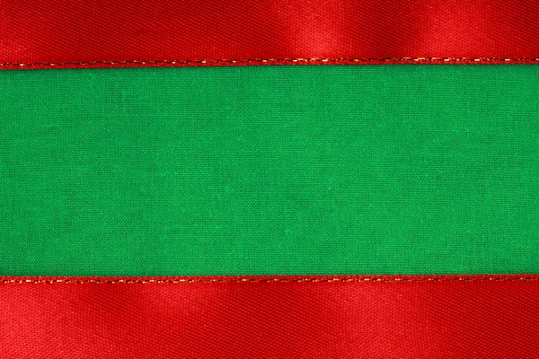 Red ribbon on green fabric background with copy space. — Stock Photo, Image